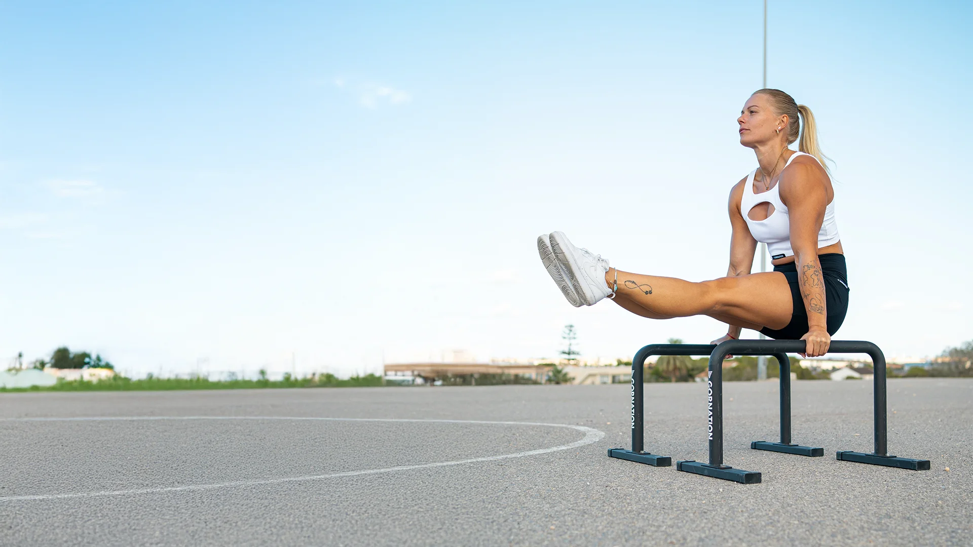 L-sit på parallettes utomhus